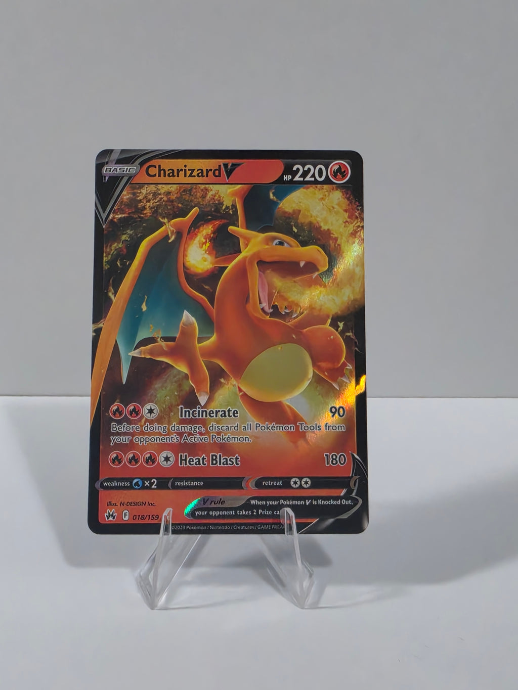 Charizard trading card in a clear protective holder on a white background