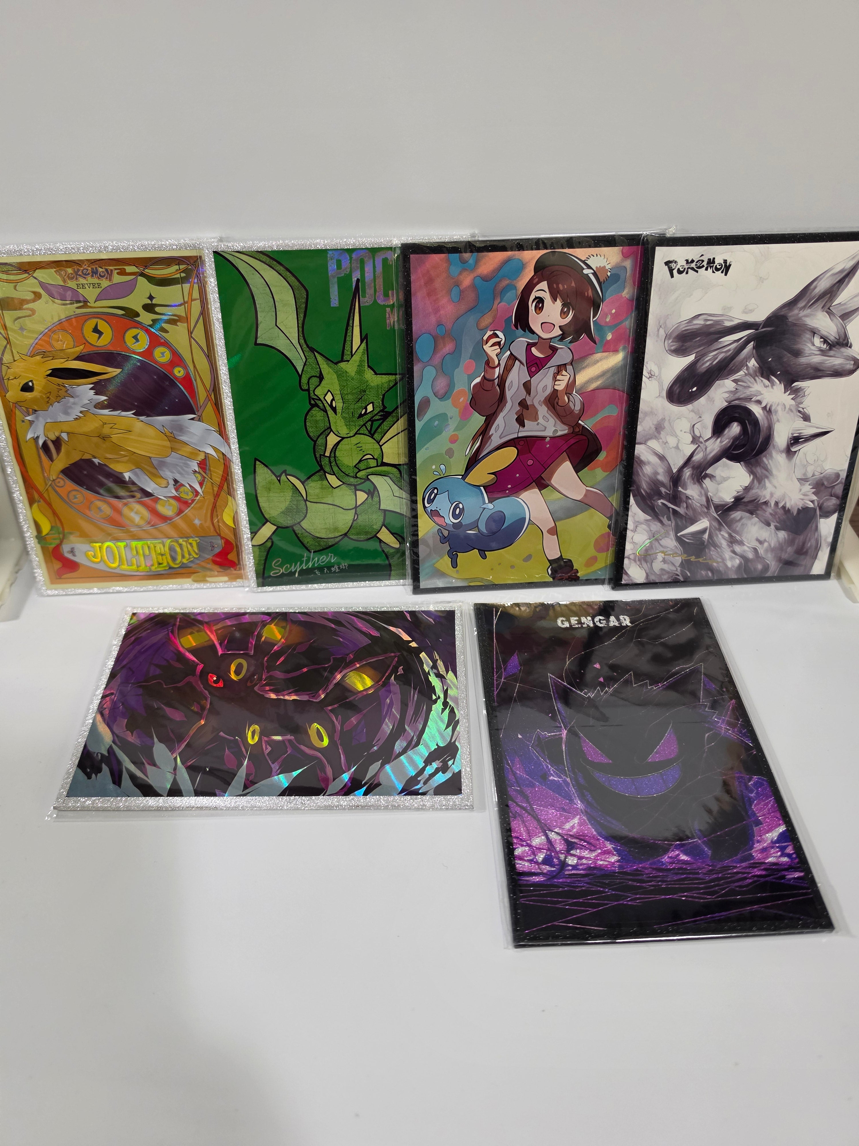Collection of colorful trading cards displayed on a white wall.